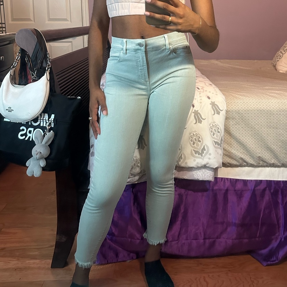 Mint green raw hem skinny jeans